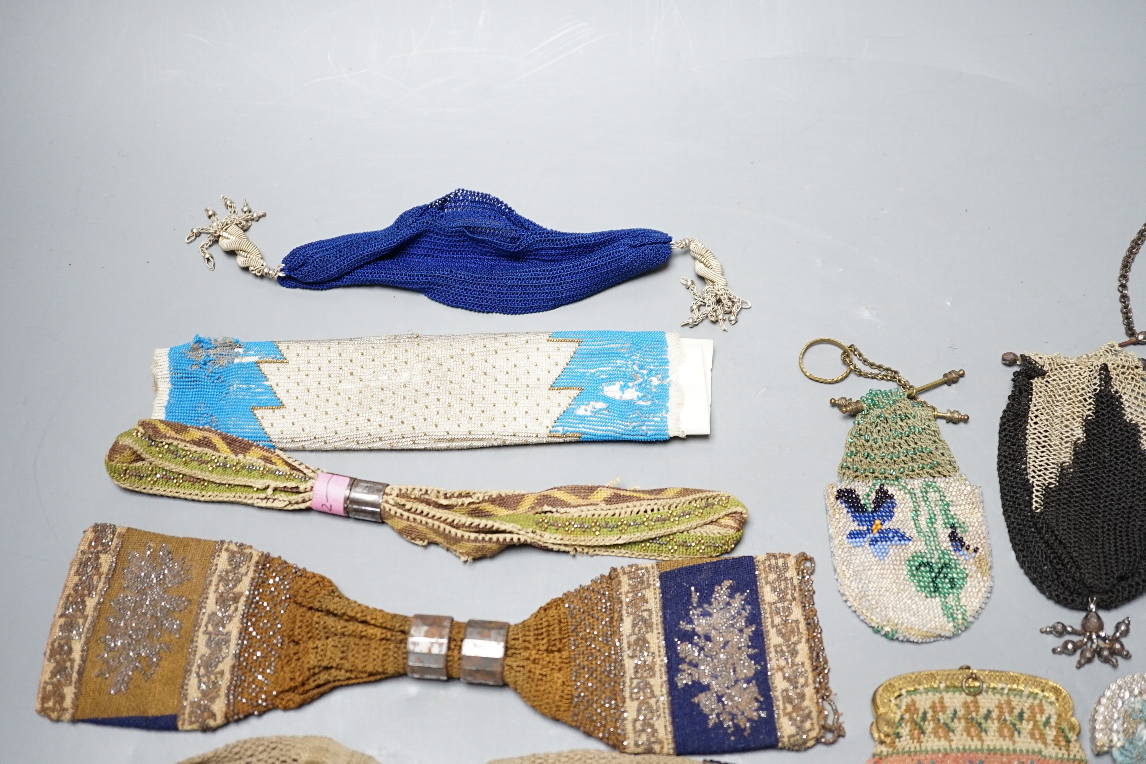 Seven 19th century cut steel misers purses, five beaded and knitted metal framed purses, two reticules, two novelty knitted jug shaped purses and two others